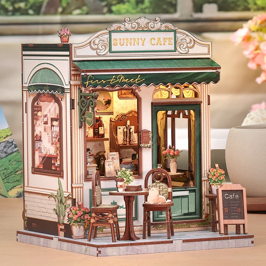 Terraza exterior en miniatura del Book Nook Cafetería con mesa y gatito